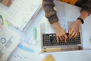 Une comptable, armée de documents et d'un ordinateur portable - journée de solidarité - Activ Consulting